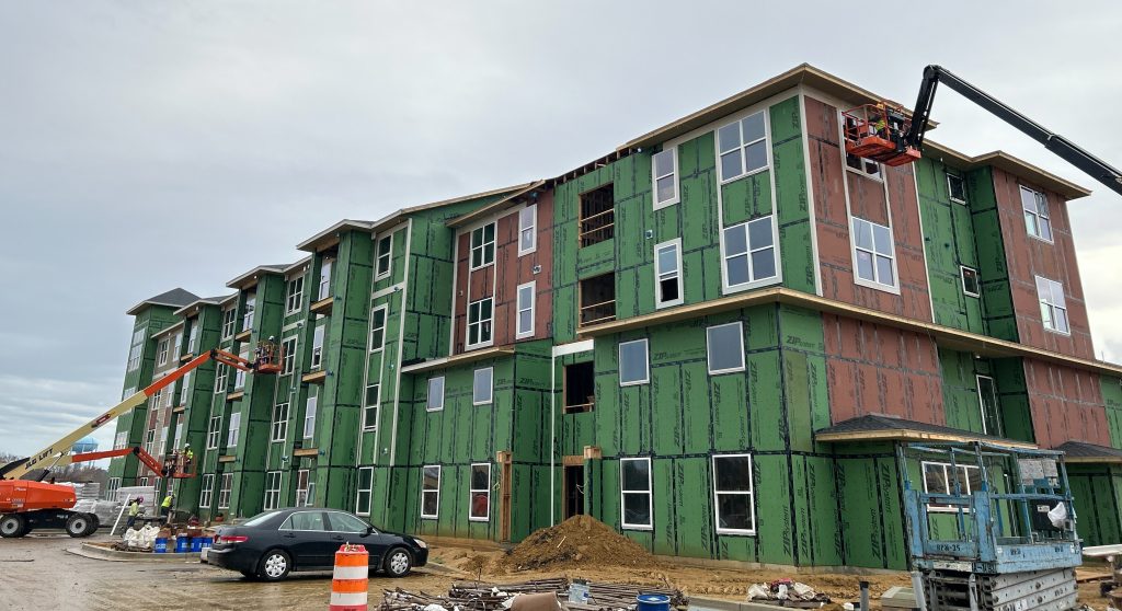 Outside look of Waldorf Station Apartments getting windows installed.